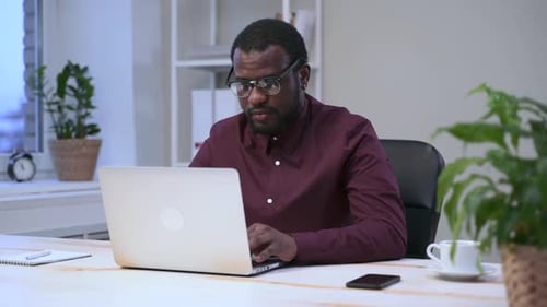 Man Working at Computer in Office Setting