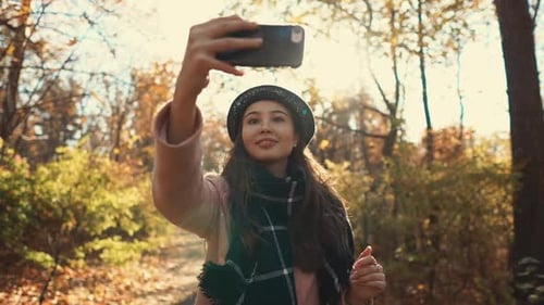 Woman Taking Selfie in Autumn Forest