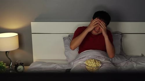 Man Reacts to Movie While in Bed