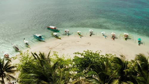 Tropical Guyam Island with a Sandy Beach and Tourists