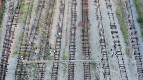 Empty parallel railway tracks in a train station. Rails, ties and ballast of a permanent way