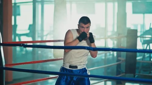 Man Shadow Boxing in Bright Urban Gym