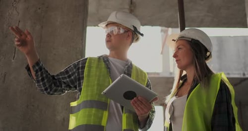 Portrait of Construction Engineers Working on Building Site