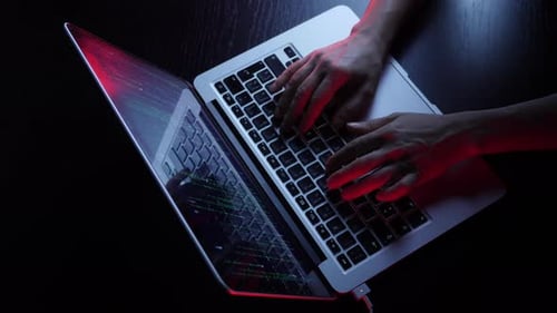 Hacker hands programming on computer and breaking password. Online security concept