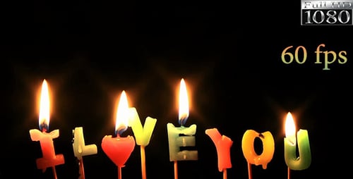 Lit Candles Spell I Love You on Dark Background