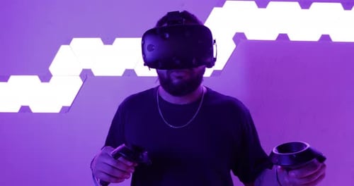 Man Using Virtual Reality Headset and Controllers