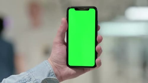 Hand Holding Smartphone with Green Chroma Screen