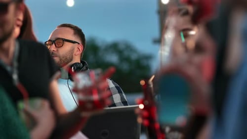Hipster Male DJ Dancing Enjoying Music Audio Sound at Night Roof Party with Friends People Crowd