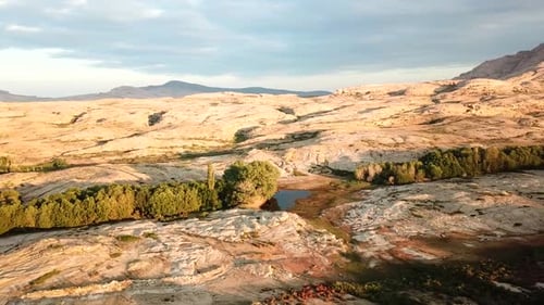 Majestic Aerial View of Desert Landscape with Pond