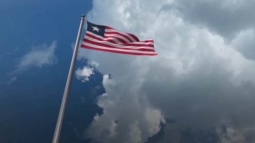 Waving Liberia Flag Against Cloudy Sky