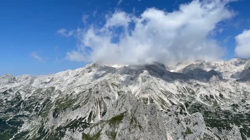 Aerial View of Majestic Mountain Landscape Under Blue Sky