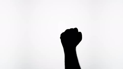 Silhouette Hand Clenching into Fist on Light Background