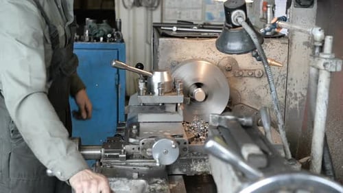 Lathe Shaping Metal in Brightly Lit Workshop