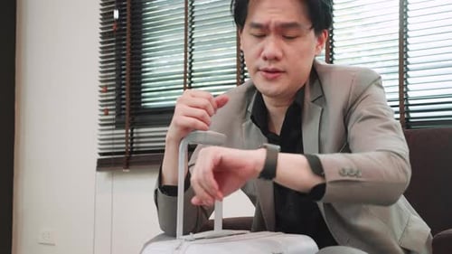 stressed businessman in airport, flight delay and cancellation, business travel