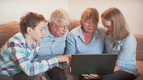 Family Gathers Around Laptop at Home