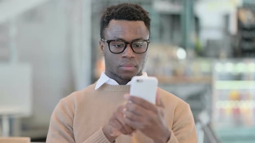 Young Adult Using Smartphone Indoors