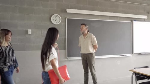 Students Arrive for Class with Teacher Waiting