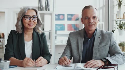 Business Colleagues Talking at a Table in an Office