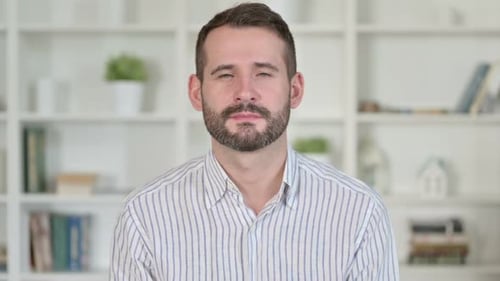 Man Smiling Portrait in Front of White Bookshelf