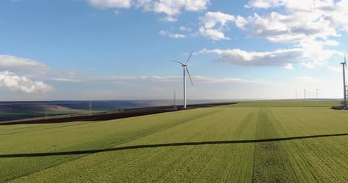 Aerial View of Wind Turbines in Green Field