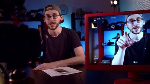 Man Explaining Technology with Monitor and Camera Set Up