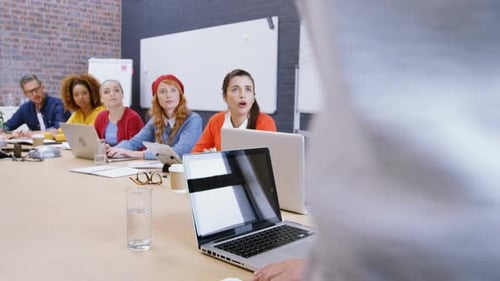 Diverse Team Attends Meeting in a Modern Office