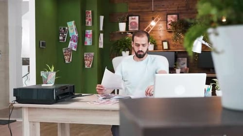 Company Art Director Sitting at This Office Checking His Last Design Sketchges