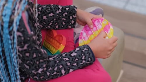 Child Playing with Pop It Fidget Toy