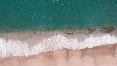 Sea waves hitting sandy beach