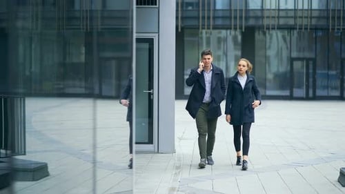 Two Business Colleagues Walking Outside Office