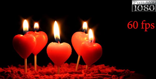 Glowing Red Heart Candles Burning in the Darkness