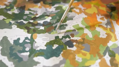 Paintbrush Painting Sectioned Canvas with White Paint