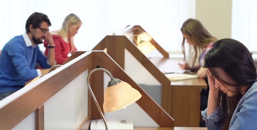 Students Studying Together at Library Desks