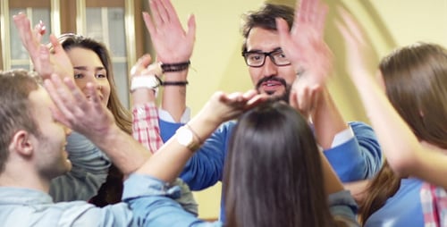 Enthusiastic Friends Gather for High Five and Embrace
