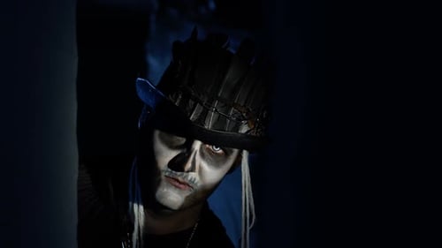 Creepy Man with Halloween Skeleton Makeup Slowly Appears From Dark Corner, Trying To Scare