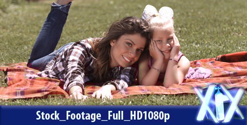 Woman and Child Lying on Blanket in Park