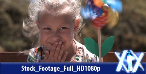 Child with a Pinwheel Outside on a Sunny Day