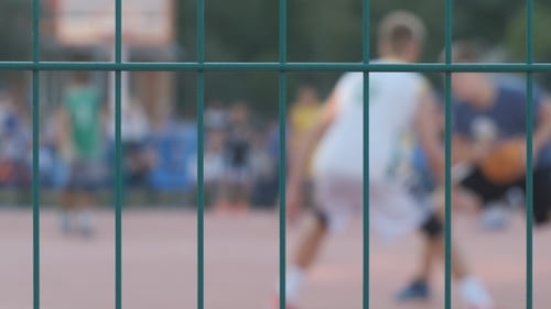 Junge Leute spielen Basketball im Freien