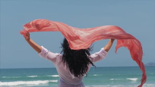 Young Girl Walking on the Beach, Running To the Sea Holding a Paladin. Concept of Travel, Sea Waves