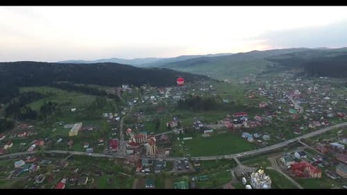 Inflatable Balloon Flies Over a Small Town. Aerial View