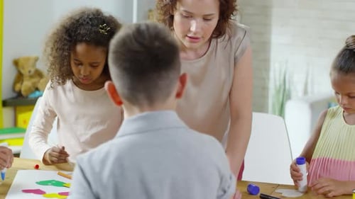 Children Creating Colorful Art Project in Classroom