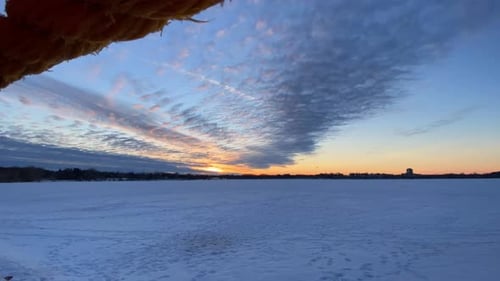 Clouds rolling over a Frozen lake in Minnesota after sunset, Time lapse
