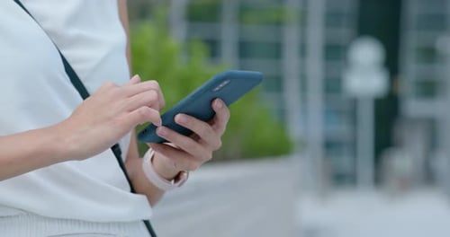 Person Using a Smart Phone in Urban Setting