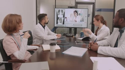 Doctors Teleconference About Medical Case in Meeting Room