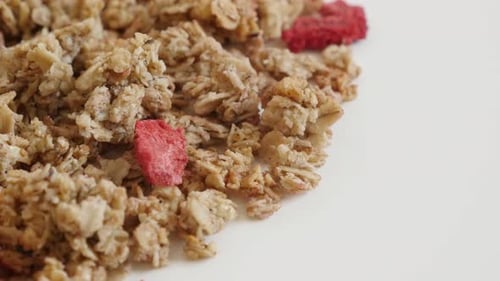 Healthy dehydrated crunchy cereals slow tilt 4K 2160p 30fps UltraHD footage - Tilting over muesli