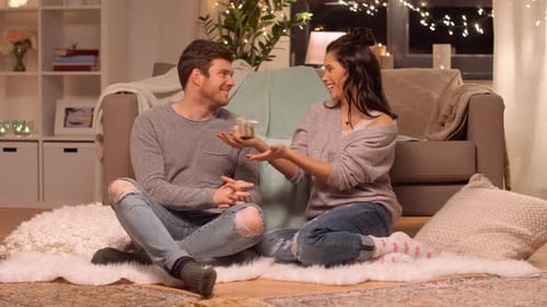 Woman Receives a Gift from Man at Home