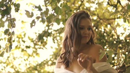 Beautiful Young Sexy Girl In A White Shirt Walks Along River Bank Among Trees