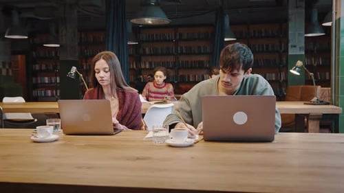 Group of Millennial Students Engaged in Learning at Public Library