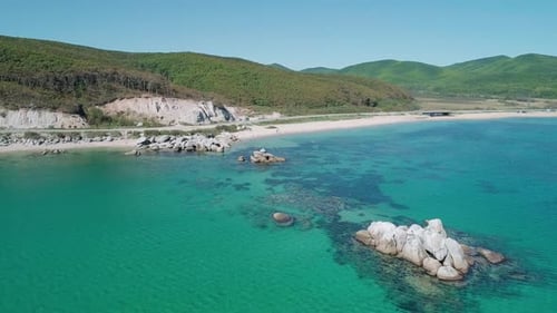Aerial View of a Beach Turquoise Water and Huge Rocks in the Sea