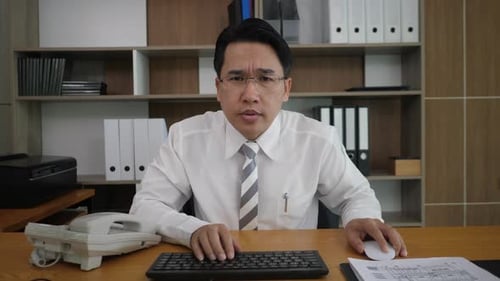 Man at Desk Typing at Keyboard Office Setting